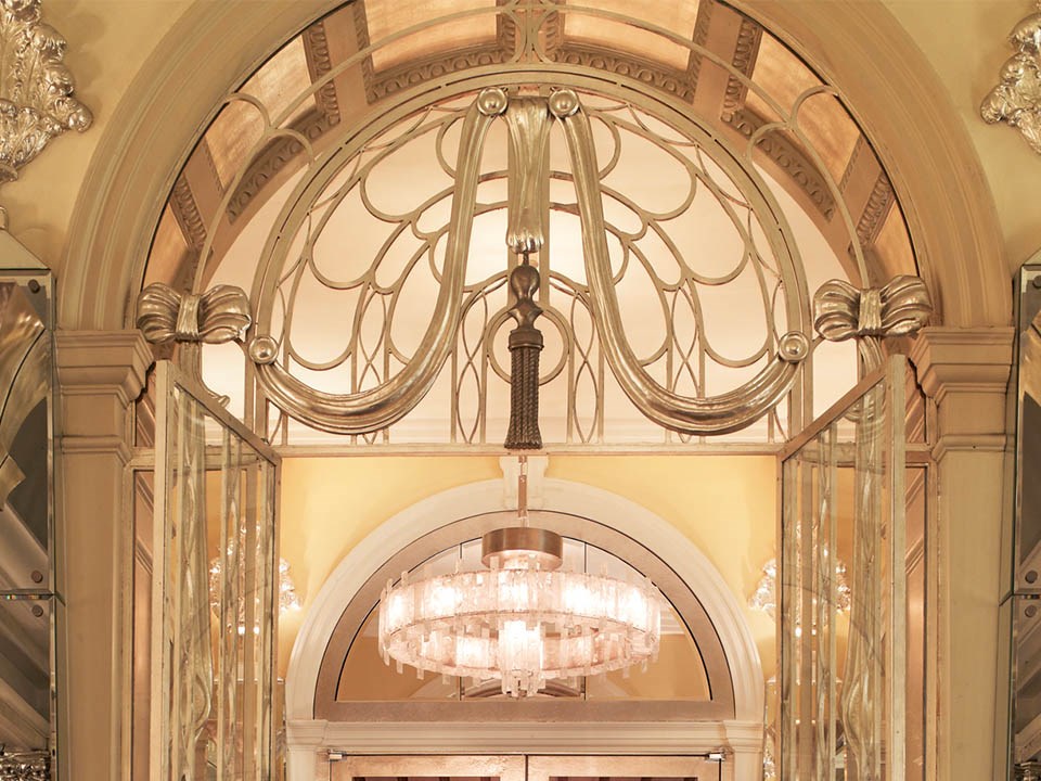 Chandeliers and gold ornaments from the Art Deco era can be seen at Claridge's Hotel.