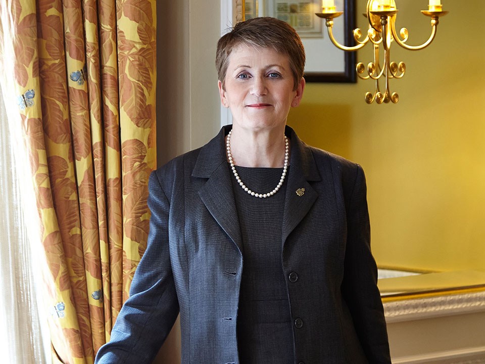 Portrait of smiling Deputy Head Housekeeper Anne Barnes in Claridge's warm atmosphere.