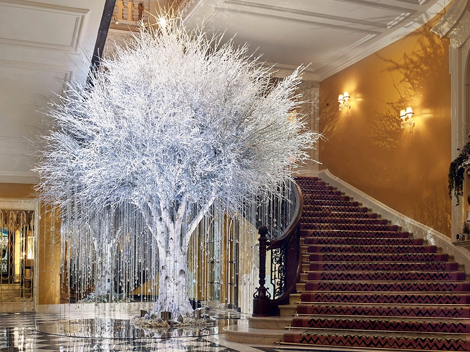 In 2020 Claridge's Christmas Tree was created by McQueens Flowers with a white frosted tree adorned with shimmering swathes.