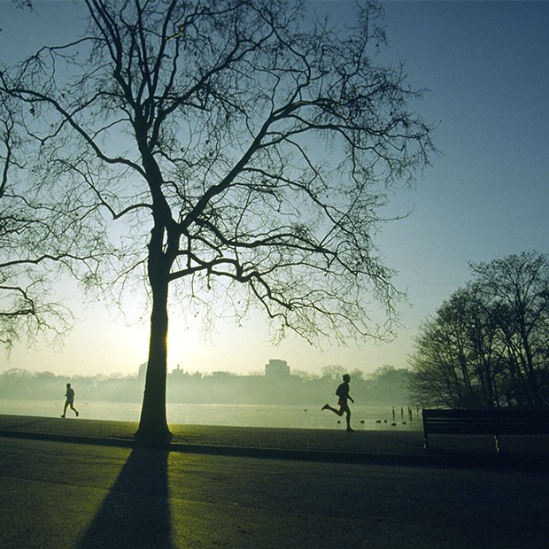 A view of runners and joggers in the early morning around Hyde Park, where guests are enjoying themselves recreationally.