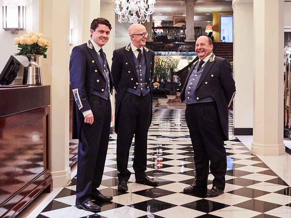Photo of smiling concierge and The Hotel Ambassador, Martin Ballard, in the corridor of Claridge's Hotel.