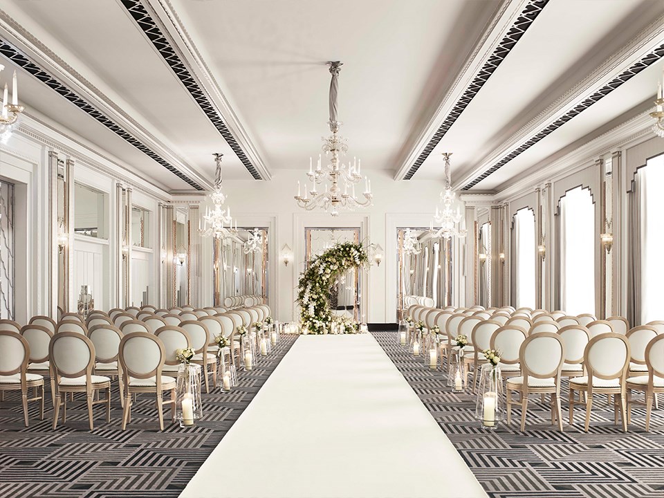 A wedding setting, with chairs and floral arrangements in a romantic art deco atmosphere in the Ballroom at Claridge's.
