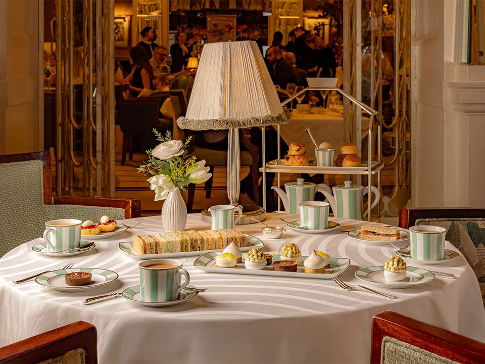 A refined afternoon tea setting at Claridge’s, with an elegant arrangement of pastries, freshly brewed tea, delicate finger sandwiches, and classic scones, complemented by the sophisticated ambiance of the tea lounge.