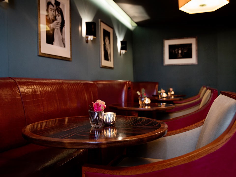 A view of the part of Claridge's Bar called The Snuggery and its intimate atmosphere and comfortable booths and chairs.
