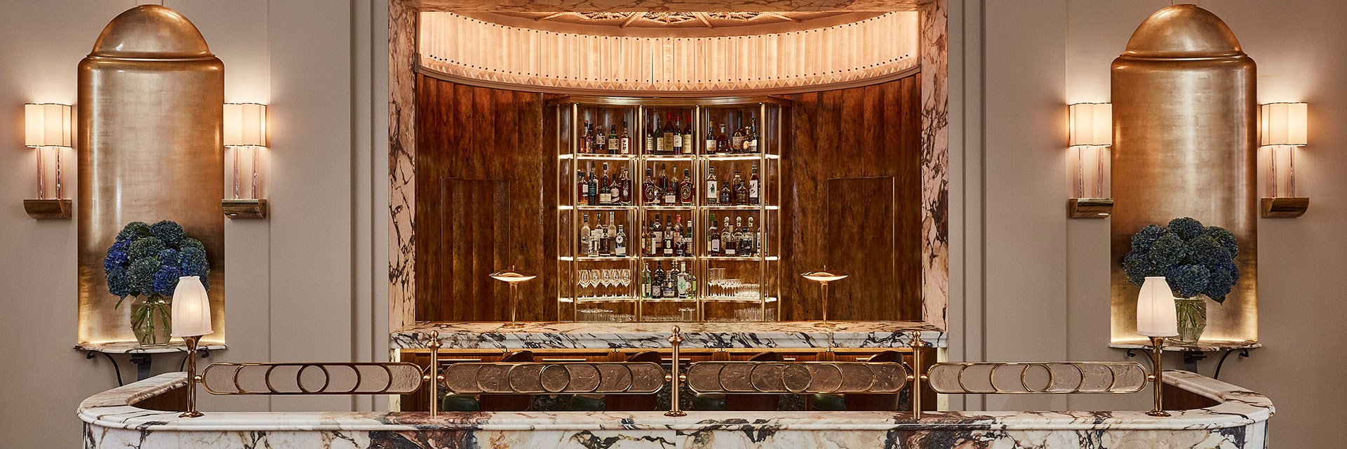 The bar at Claridge's Restaurant with bottles and bar stools