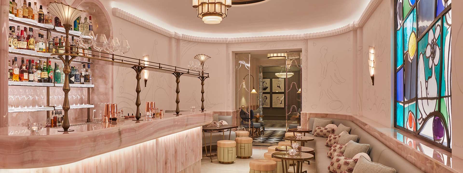 The pink interior design of The Painter's Room cocktail bar at Claridge's Hotel, with plenty of seating.