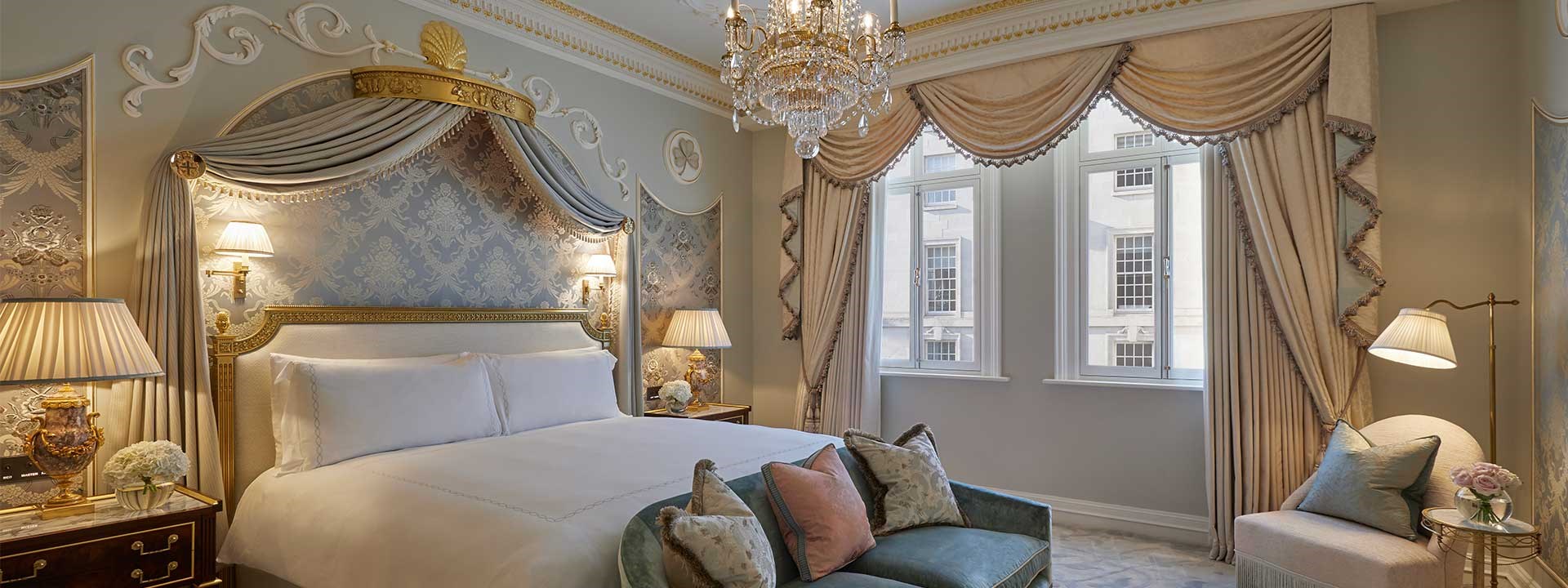 Royal Suite at Claridge's - bedroom with bed, bedside table and sofa next to the bed.