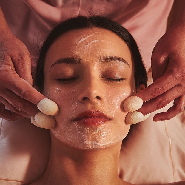 A view of a woman having a facial spa treatment, in the soothing atmosphere of Claridge's Spa.