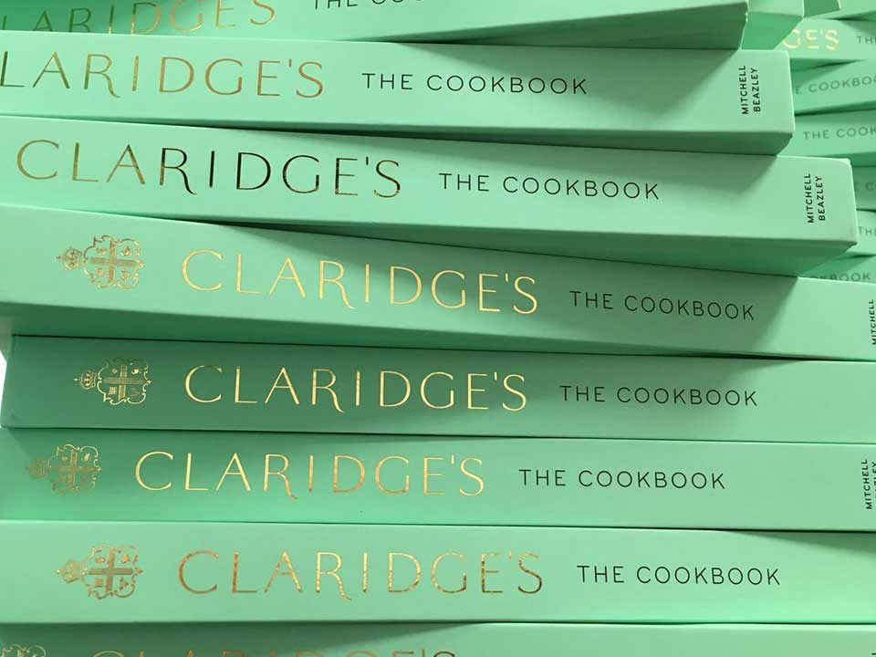 A presentation of Claridge's cookbooks arranged in their mint green colour cover with gold font.