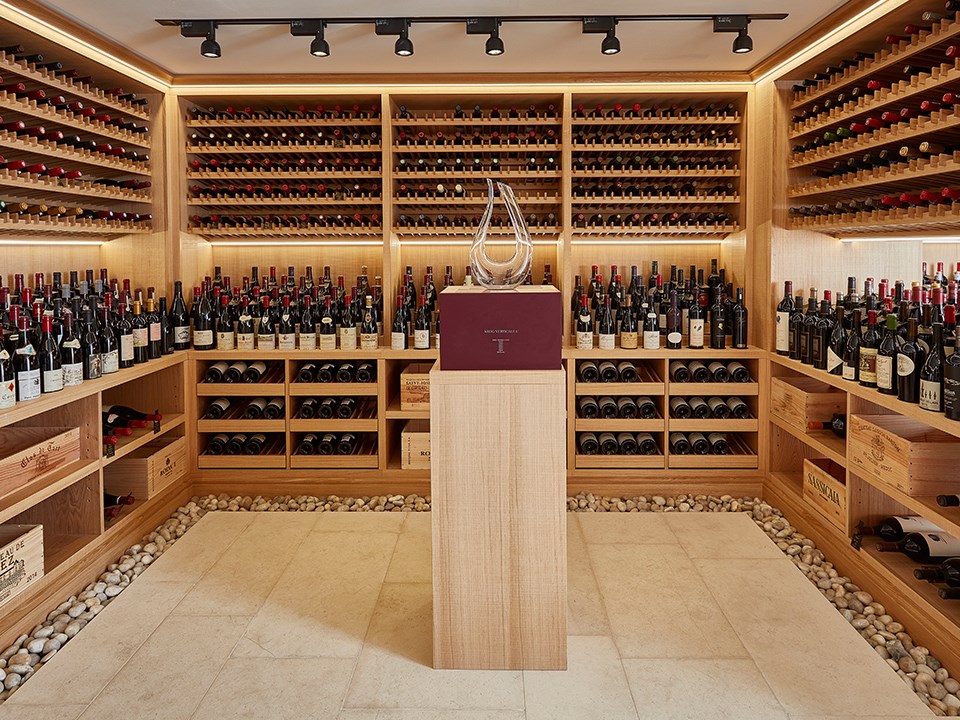 Arranged different and delicious wines on the shelves, in the premises of the wine cellar, from The Claridge's Hotel.
