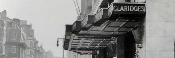 Historic black and white photograph of Claridge’s hotel exterior and entrance canopy on a London street.