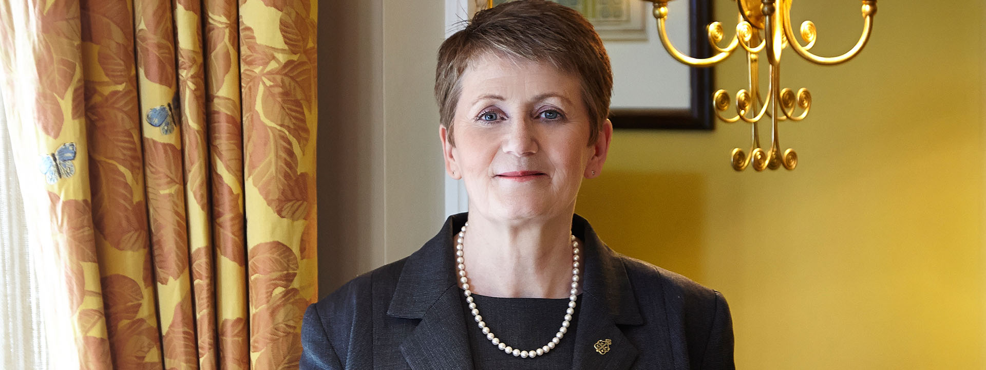 Portrait of smiling Deputy Head Housekeeper Anne Barnes in Claridge's warm atmosphere.