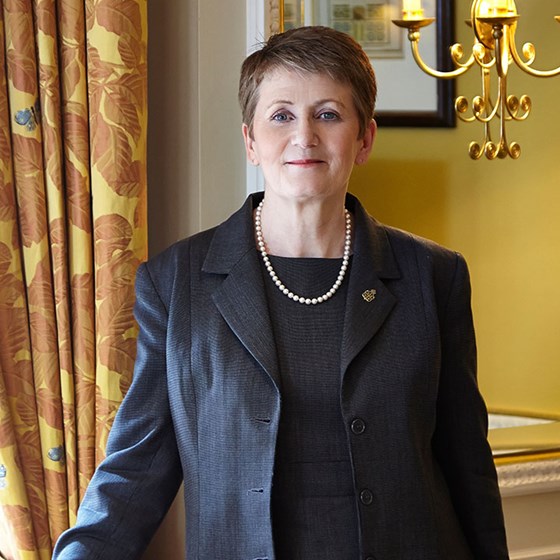 Portrait of smiling Deputy Head Housekeeper Anne Barnes in Claridge's warm atmosphere.