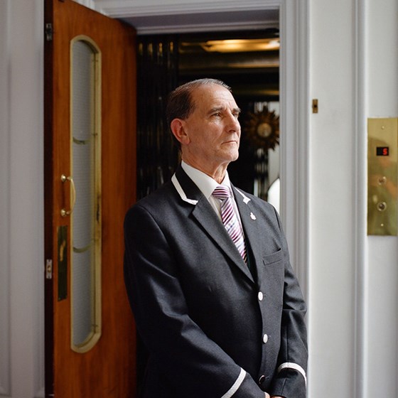 Portrait of John Alves, the custodian of the last man-operated lift in London at Claridge's.