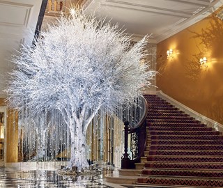 In 2020 Claridge's Christmas Tree was created by McQueens Flowers with a white frosted tree adorned with shimmering swathes.