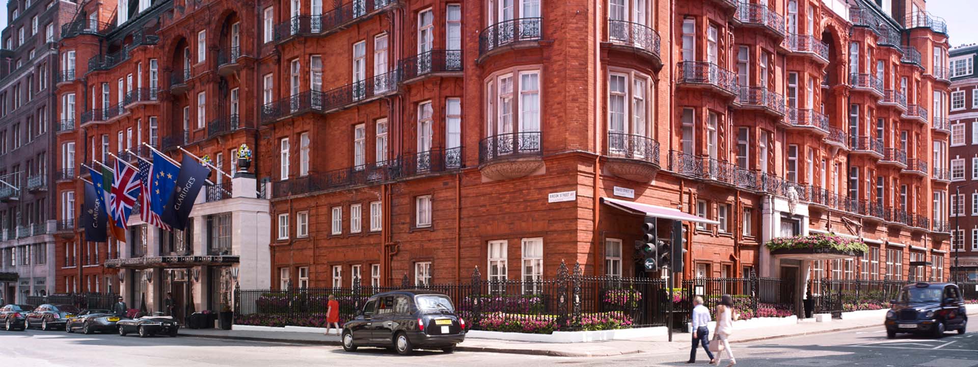 Street view from where we can see Claridge's Hotel, cars, hotel entrance and passers-by.