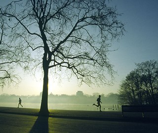 A view of runners and joggers in the early morning around Hyde Park, where guests are enjoying themselves recreationally.