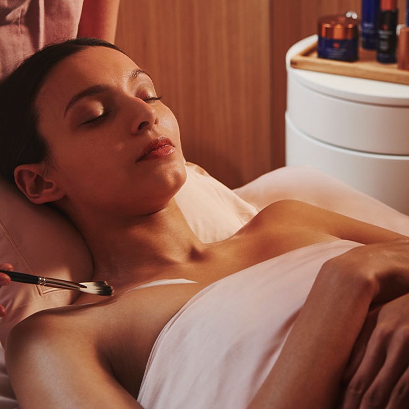 A view of a girl enjoying a gentle treatment from Claridge's Spa, with a wellness professional applying the treatment.