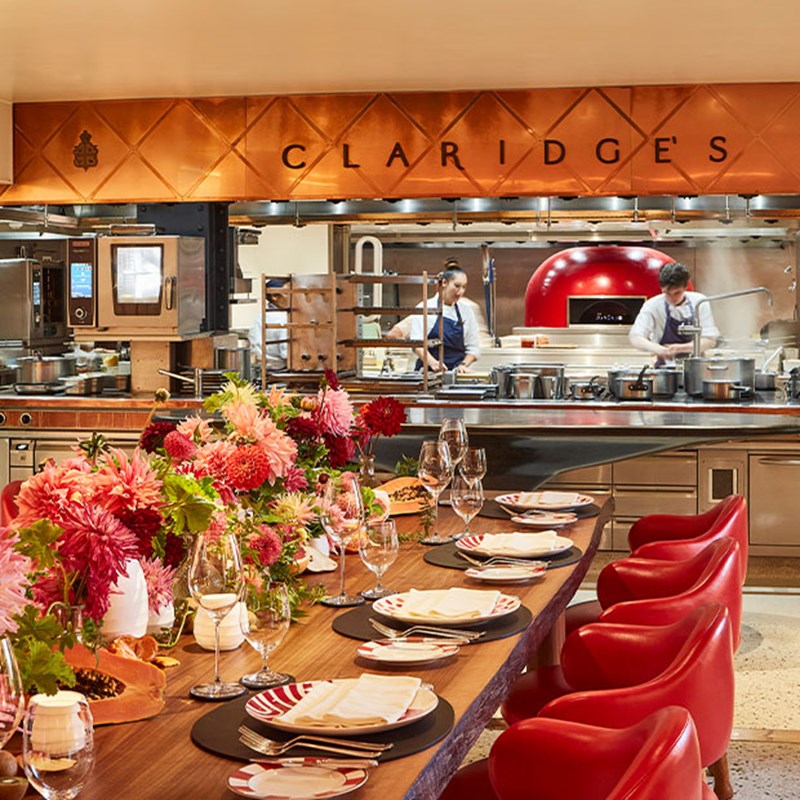 L'Epiciere with long table and chairs and view into open kitchen.