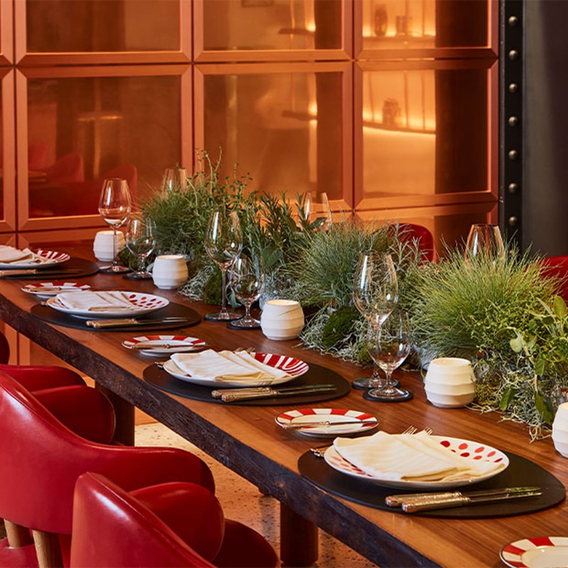 Close up of aesthetic tablescape at L'Epiciere, with grass like plants forming the tablescape.