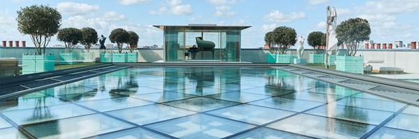 Rooftop glass water feature leading to glass pavilion with grand piano inside