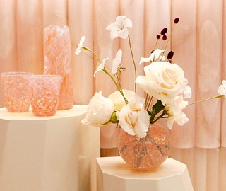 Claridges c Curio - view of pink vases with flowers in one of them.