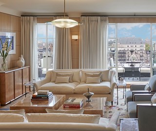 Cream sofas and brown coffee table in living room of suite