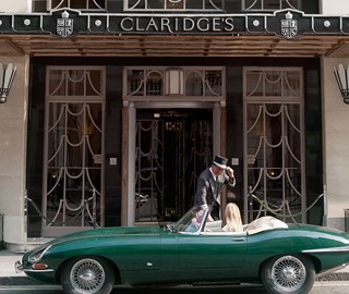 Claridge's hotel exterior with car outside and doorman greeting guest