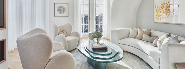 White sofas and coffee table in light living area of suite