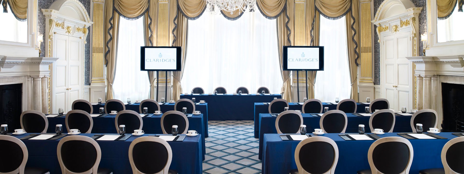 A view of the Drawing room in the French Salon, with many chairs and tables, designed in blue and beige colours.