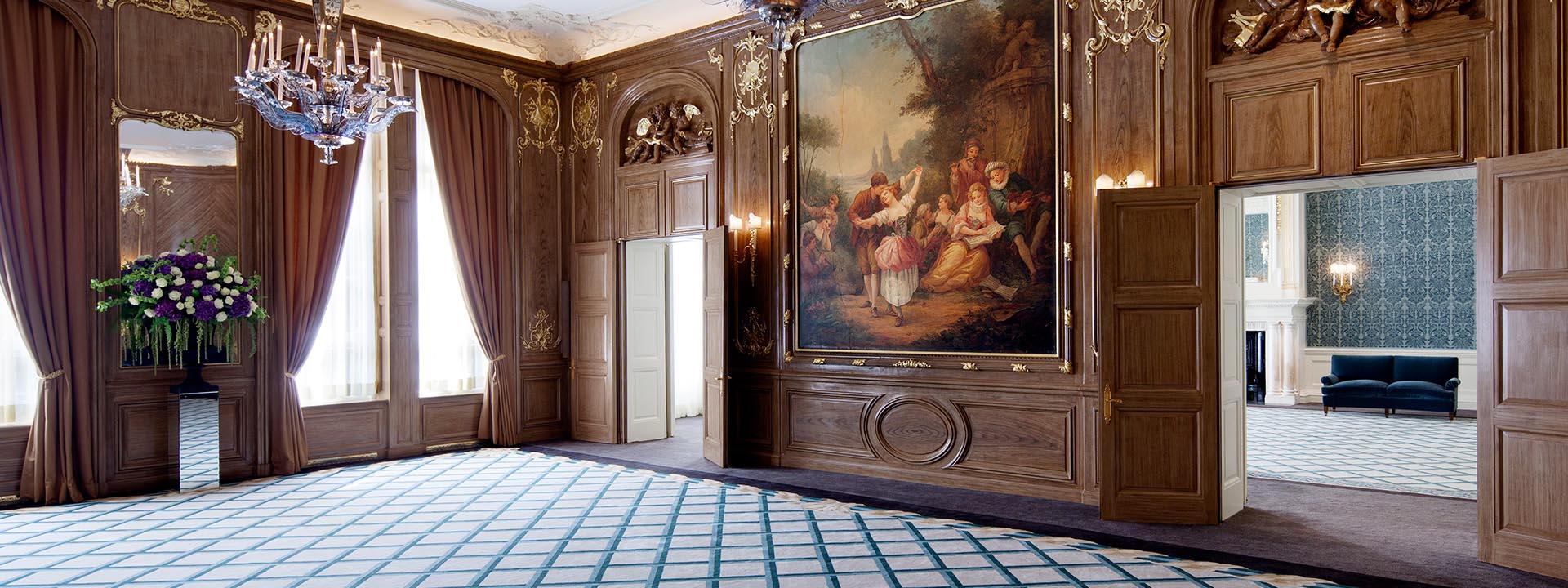 A view of the French Salon and Renaissance-style cherubs over the doors and a mural of a dancing couple.