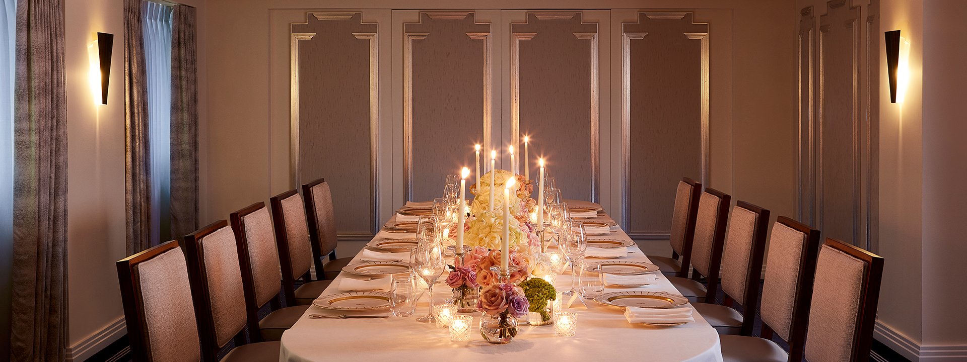 Highgrove room at Claridge's, with a table dressed with a white tablecloth, plates and some flowers.