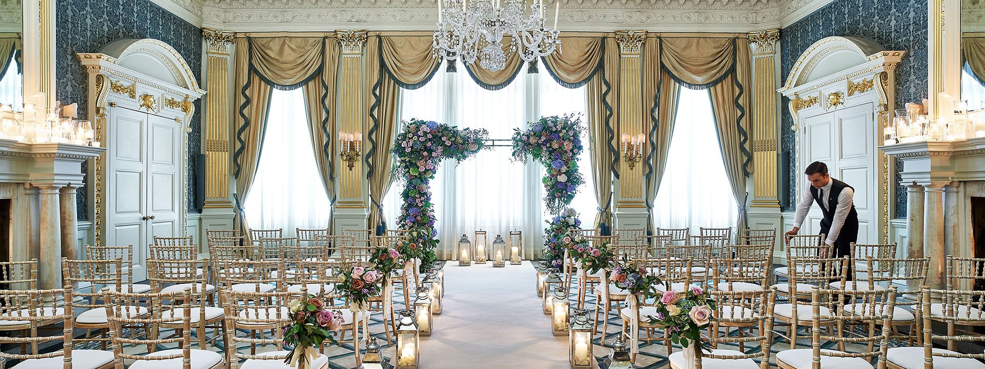 A view of the Drawing Room when it is transformed for wedding purposes, decorated with flowers and candles.