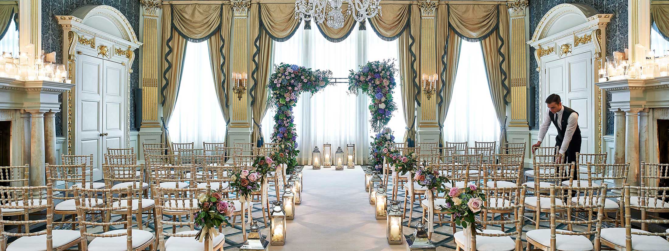 A view of the Drawing Room when it is transformed for wedding purposes, decorated with flowers and candles.