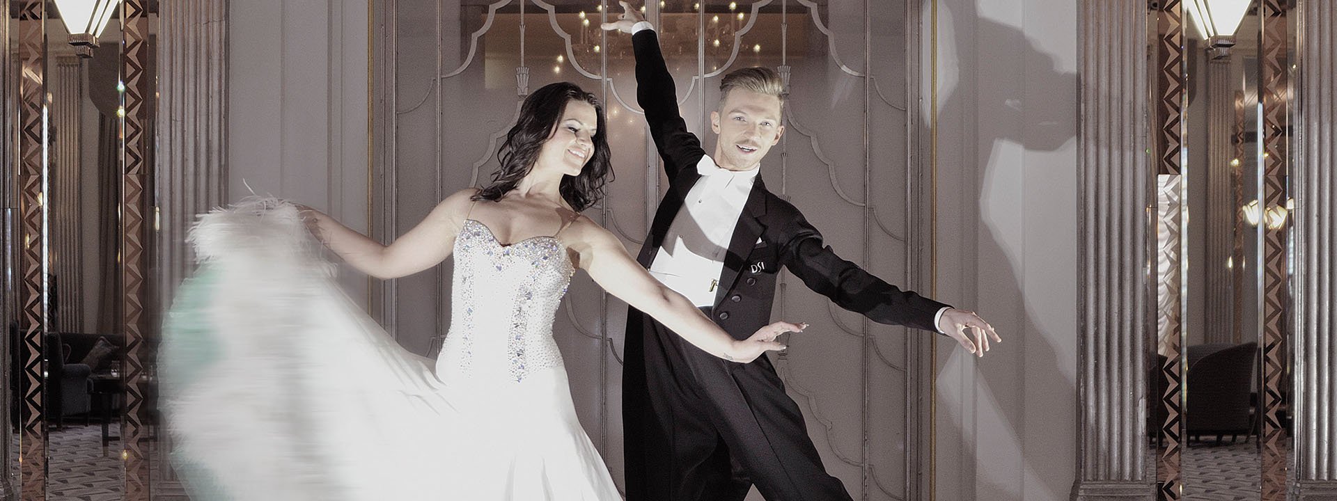 Photo of two smiling choreographers dancing the foxtrot at Claridge's Hotel.