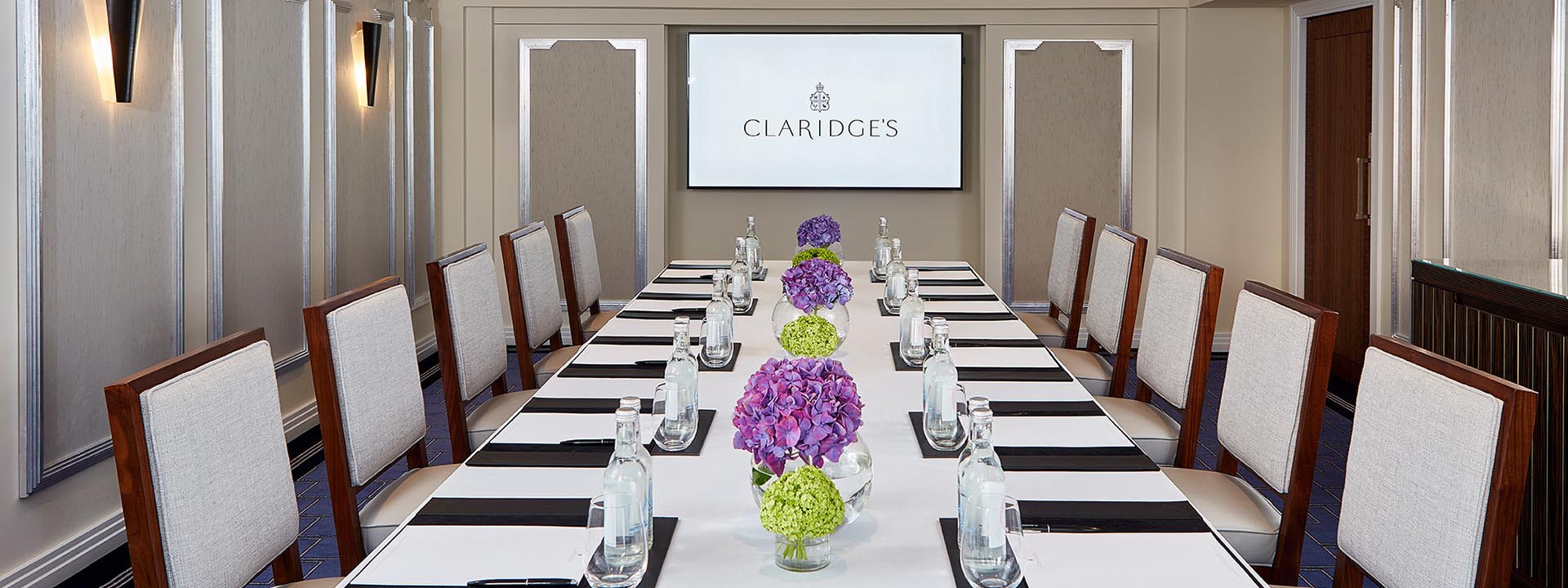 A view of the table set with floral arrangements, for a business meeting, in the Windsor Room.