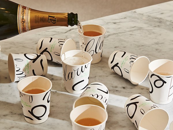Champagne poured in Claridge's ArtSpace Café branded cups to go.