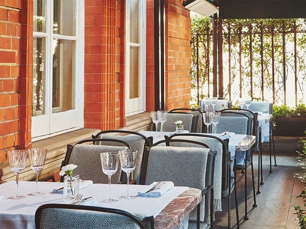 Claridge's Bar Terrace with rows of tables and chairs laid up.