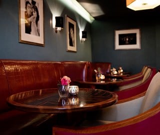 A view of the part of Claridge's Bar called The Snuggery and its intimate atmosphere and comfortable booths and chairs.