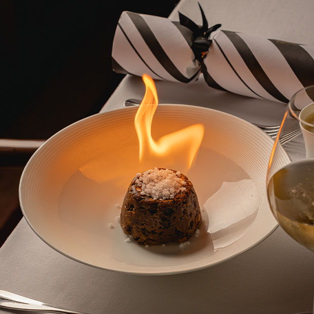 Traditional Christmas pudding flambéed with brandy, topped with sugar crystals.