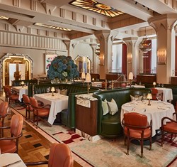 Claridge's restaurant room view, tables with table cloths, chairs and flowers