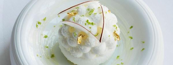white dessert with gold fleck and green sprinkles