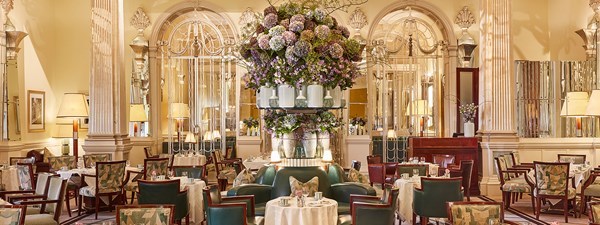 Claridge's Foyer and Reading Room - empty room with tables and chairs and flowers in the centre.