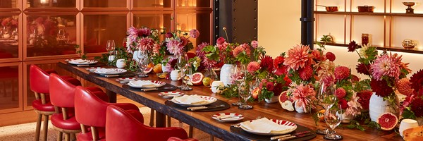 The table of L'Epicerie at Claridge's, with tableware and flowers on top.