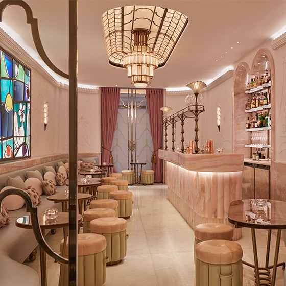 Pastel pink interior design of The Painter's Room cocktail bar at Claridge's Hotel.