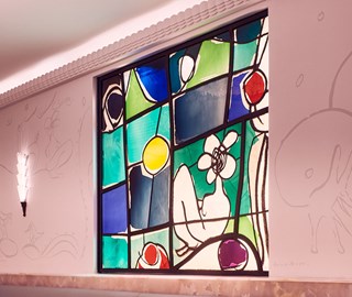 A stained glass window by Annie Morris inside the Painter's Room at Claridge's.