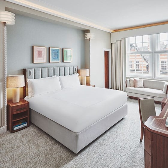 claridges room bed and desk with books