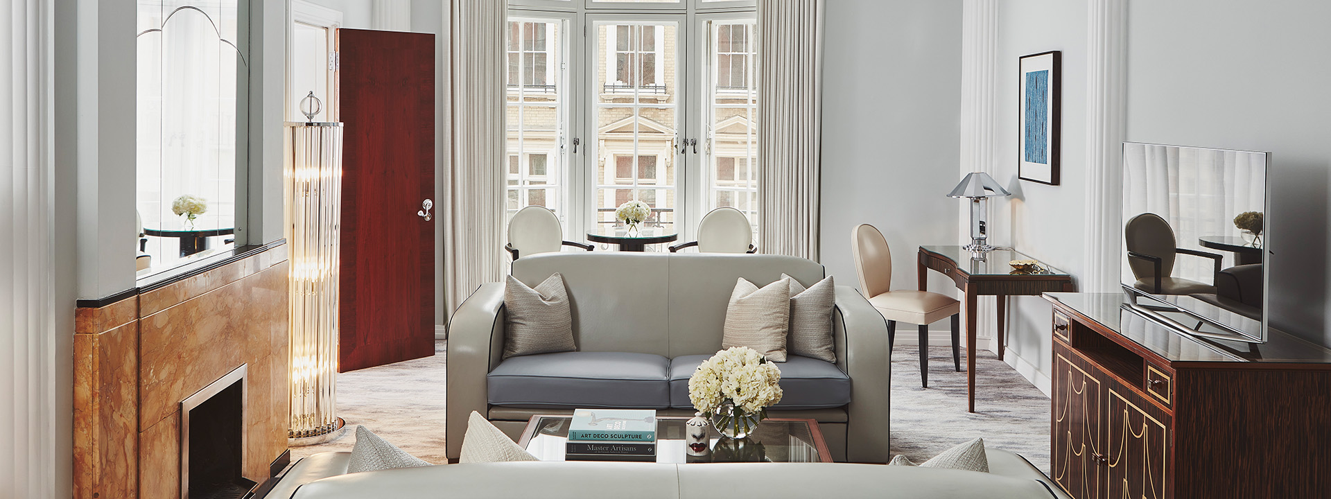 A view of the sofa in Claridge's Suite, with luxurious interior details and lots of natural daylight.