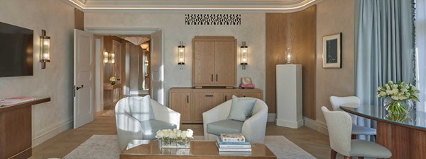 Part of the living room with two armchairs in Claridge's Terrace Suite, in a classic interior design, with art deco elements.