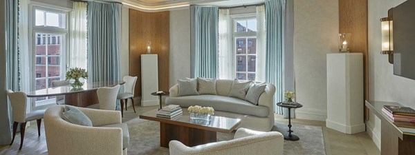 A spacious living room and comfortable furniture in a classic interior design in Claridge's Terrace Suite.